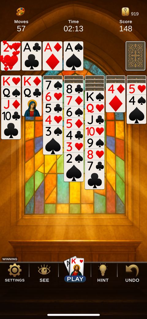 A game of solitaire in progress on the stained-glass table, with Moves, Time and Score along the top